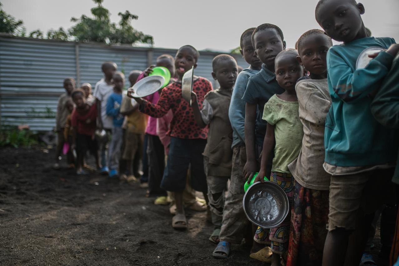Children waiting in line with bowls at the distribution site in Sak&eacute;.